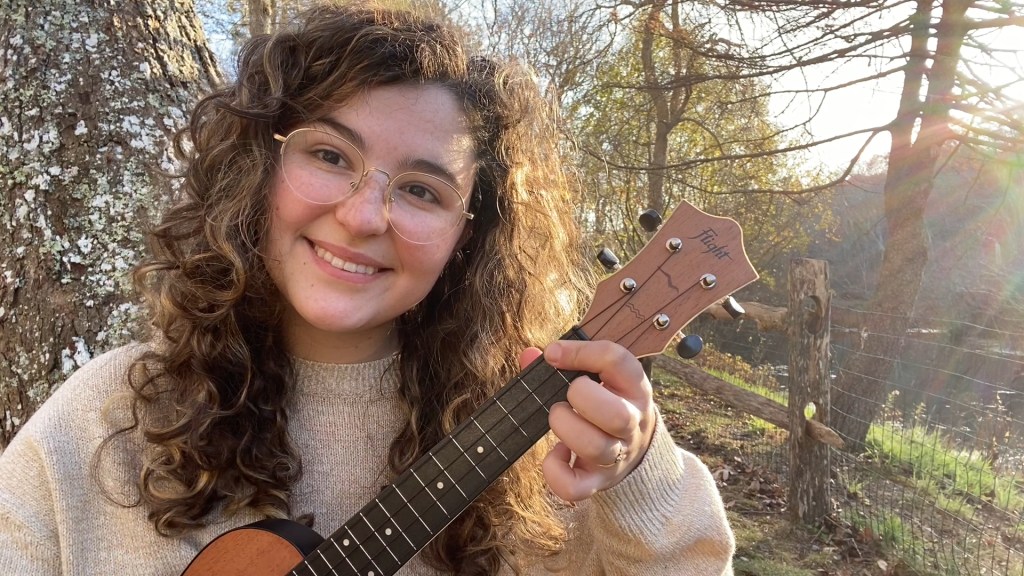 Victoria "Viggy" Kolasinski with ukulele outdoors.